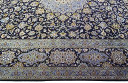 Corner detail of 2000s Kashan rug showing border pattern and Cork pile
