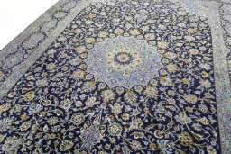 Backside of handmade 2000s Kashan rug showing knot structure and weave density