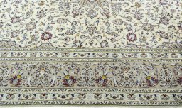 Corner detail of 2000s Kashan rug showing border pattern and Wool pile