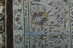 Backside of handmade 2000s Kashan rug showing knot structure and weave density