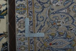 Backside of handmade 2000s Kashan rug showing knot structure and weave density