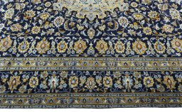 Corner detail of 1970s Kashan rug showing border pattern and Wool pile