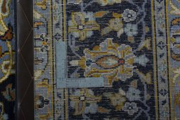 Backside of handmade 1970s Kashan rug showing knot structure and weave density