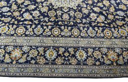Corner detail of 2000s Kashan rug showing border pattern and Wool pile