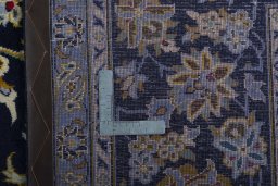 Backside of handmade 2000s Kashan rug showing knot structure and weave density