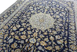 Backside of handmade 2000s Kashan rug showing knot structure and weave density