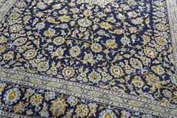 Close-up detail of 2000s Kashan rug from Iran / Persia showing Wool weave