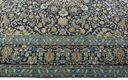 Corner detail of 2000s Kashan rug showing border pattern and Wool pile