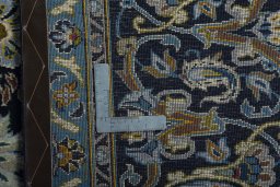 Backside of handmade 2000s Kashan rug showing knot structure and weave density