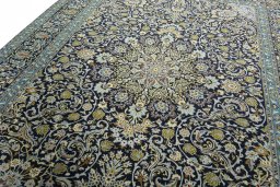 Backside of handmade 2000s Kashan rug showing knot structure and weave density
