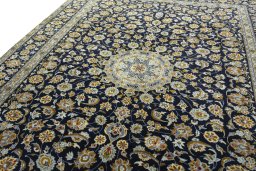 Backside of handmade 2000s Kashan rug showing knot structure and weave density
