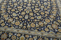 Close-up detail of 2000s Kashan rug from Iran / Persia showing Wool weave