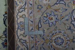Backside of handmade 1970s Kashan rug showing knot structure and weave density