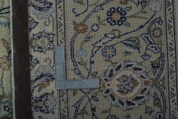 Backside of handmade 1970s Kashan rug showing knot structure and weave density