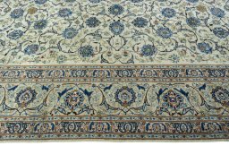 Corner detail of 2000s Kashan rug showing border pattern and Wool pile