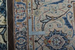 Backside of handmade 2000s Kashan rug showing knot structure and weave density