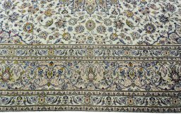 Corner detail of 2000s Kashan rug showing border pattern and Wool pile
