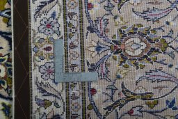 Backside of handmade 2000s Kashan rug showing knot structure and weave density