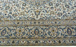 Corner detail of 2000s Kashan rug showing border pattern and Wool pile