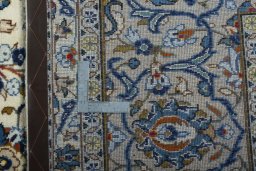 Backside of handmade 2000s Kashan rug showing knot structure and weave density