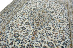 Backside of handmade 2000s Kashan rug showing knot structure and weave density