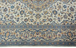 Corner detail of 2000s Kashan rug showing border pattern and Wool pile