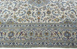 Corner detail of 2000s Kashan rug showing border pattern and Wool pile