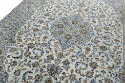 Backside of handmade 2000s Kashan rug showing knot structure and weave density
