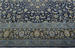 Corner detail of 2000s Kashan rug showing border pattern and Wool pile