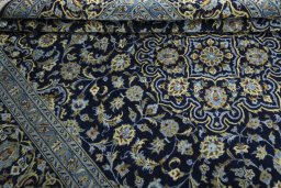 Close-up detail of 2000s Kashan rug from Iran / Persia showing Wool weave