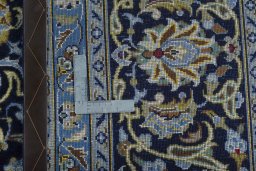 Backside of handmade 2000s Kashan rug showing knot structure and weave density