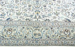 Corner detail of 2000s Kashan rug showing border pattern and Wool pile