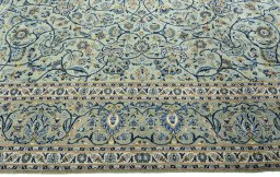 Corner detail of 2000s Kashan rug showing border pattern and Wool pile