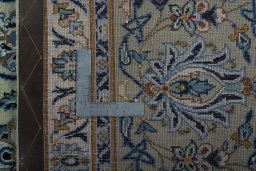 Backside of handmade 2000s Kashan rug showing knot structure and weave density
