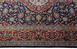 Corner detail of New Kashan rug showing border pattern and Cork pile