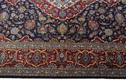 Corner detail of New Kashan rug showing border pattern and Cork pile