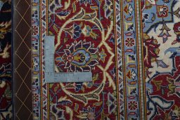 Backside of handmade New Kashan rug showing knot structure and weave density