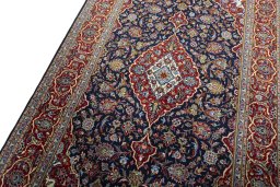 Backside of handmade New Kashan rug showing knot structure and weave density