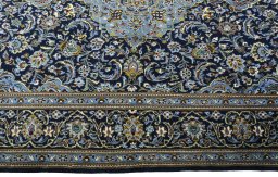 Corner detail of New Kashan rug showing border pattern and Cork pile