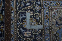 Backside of handmade New Kashan rug showing knot structure and weave density