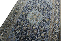 Backside of handmade New Kashan rug showing knot structure and weave density