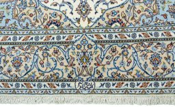 Corner detail of New Kashan rug showing border pattern and Cork pile