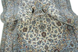 Backside of handmade New Kashan rug showing knot structure and weave density
