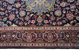 Corner detail of New Kashan rug showing border pattern and Cork pile