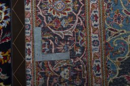 Backside of handmade New Kashan rug showing knot structure and weave density