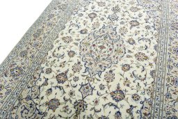 Backside of handmade 2000s Kashan rug showing knot structure and weave density