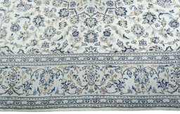 Corner detail of 2000s Kashan rug showing border pattern and Wool pile
