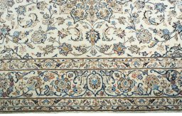 Corner detail of New Kashan rug showing border pattern and Wool pile