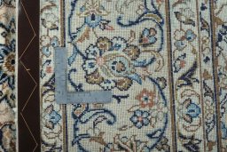 Backside of handmade New Kashan rug showing knot structure and weave density