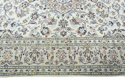 Corner detail of 2000s Kashan rug showing border pattern and Wool pile